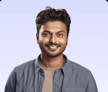 A smiling man in a denim shirt.